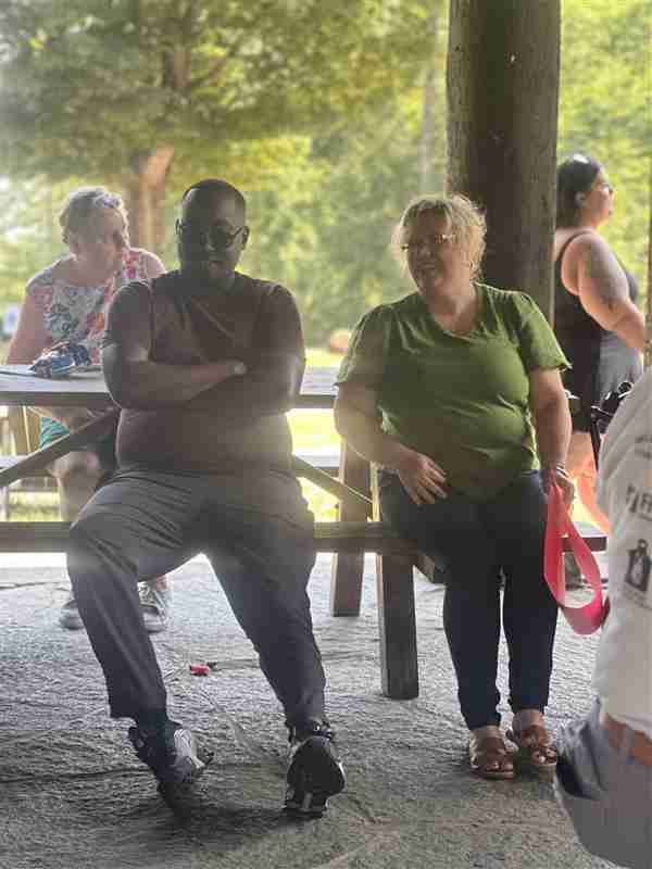 sitting at picnic tables at company bbq